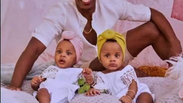 Romain Virgo poses with his twin daughters during a photoshoot.