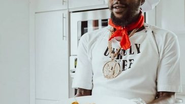 Popcaan cooking curry chicken and rice