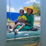 Toni-Ann Singh vibes with a young fan during the Emancipation Day float parade