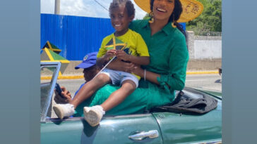 Toni-Ann Singh vibes with a young fan during the Emancipation Day float parade