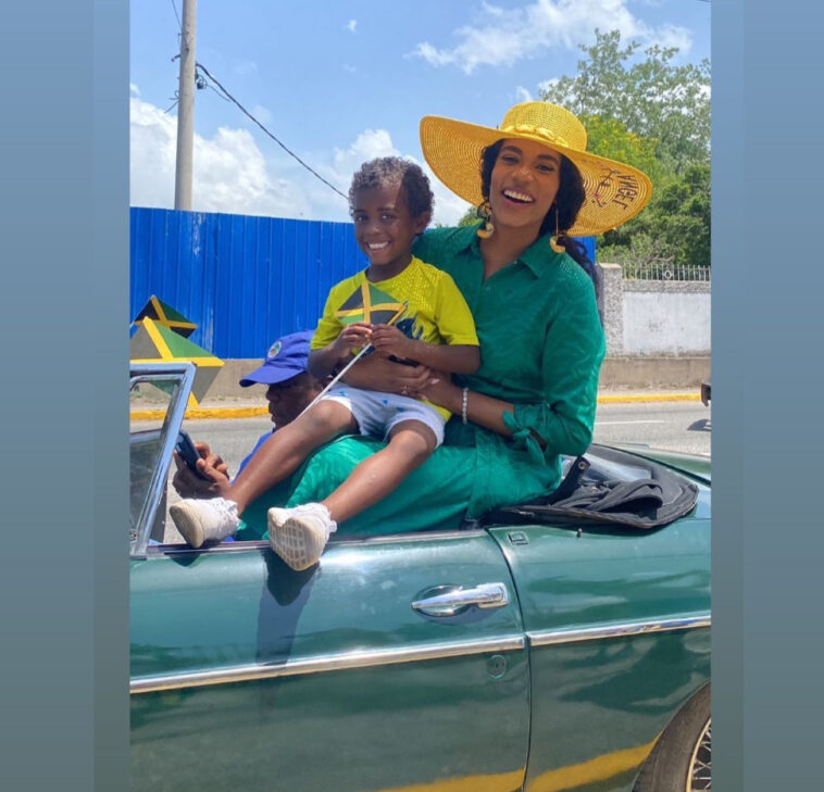 Toni-Ann Singh vibes with a young fan during the Emancipation Day float parade