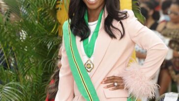 Shelly-Ann Fraser-Pryce shows her Order of Jamaica medal at the 2022 National Awards