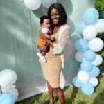 Konya Plummer poses with hew newborn son at a party