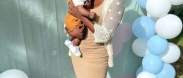 Konya Plummer poses with hew newborn son at a party