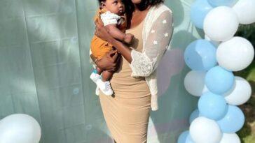 Konya Plummer poses with hew newborn son at a party