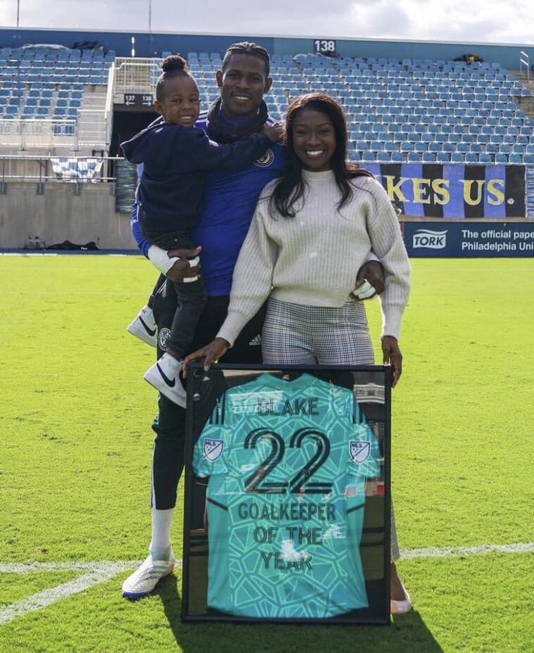 Andre Blake shows off his MLS Goalkeeper of the Year Award alongside his family