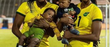 Konya Plummer and Cheyna Matthews pose with their children at the National Stadium in Kingston.