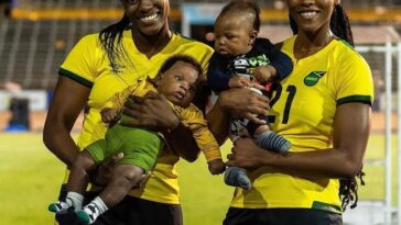 Konya Plummer and Cheyna Matthews pose with their children at the National Stadium in Kingston.