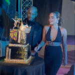 Asafa Powell cuts his 40th birthday cake alongside his wife, Alyshia Miller Powell