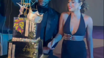 Asafa Powell cuts his 40th birthday cake alongside his wife, Alyshia Miller Powell