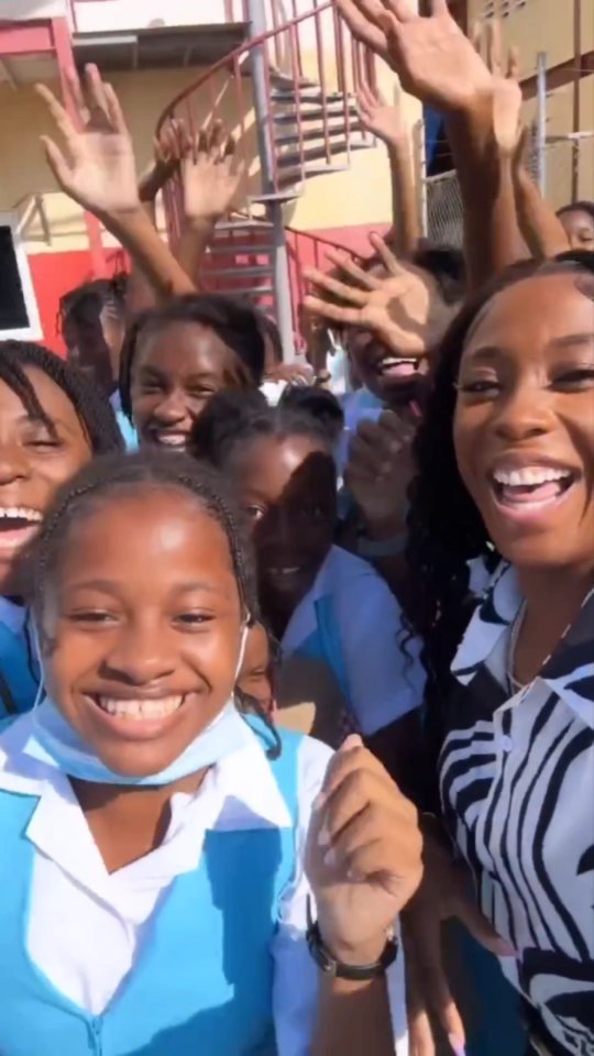 Shelly-Ann Fraser-Pryce interacts with students from her old school, Penwood Early Childhoo Institution