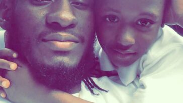 Aidonia hugging his late son, King Khalif Lawrence