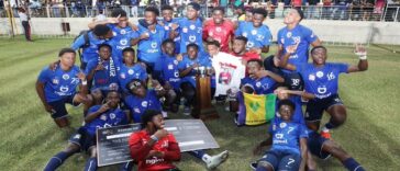 Jamaica College players and coaches celebrate after winning the 2022 Manning Cup
