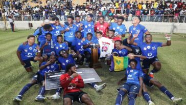 Jamaica College players and coaches celebrate after winning the 2022 Manning Cup