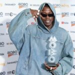 Skillibeng holds his MOBO Award on the red carpet of the 2022 MOBO Awards at the O2 Arena in London.
