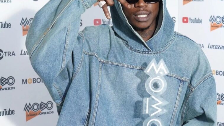 Skillibeng holds his MOBO Award on the red carpet of the 2022 MOBO Awards at the O2 Arena in London.