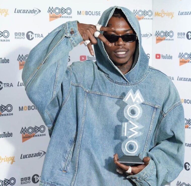 Skillibeng holds his MOBO Award on the red carpet of the 2022 MOBO Awards at the O2 Arena in London.