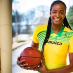 Former WNBA player Simone Edwards holds a basketball as coach of Jamaica's national basketball team.
