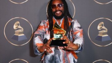 Kabaka Pyramid holds his Reggae Grammy award on the red carper at the 65th Grammy Awards in Los Angeles.