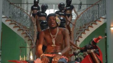 Masicka poses with women in police gear during music video for "Tyrant."