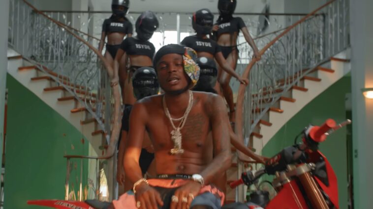 Masicka poses with women in police gear during music video for "Tyrant."