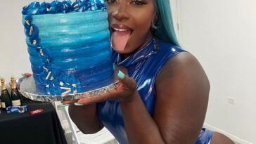 Spice holds her birthday cake after her show in Sint Maarten