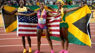 Sha'Carri Richardson, Shelly-Ann Fraser-Pryce and Shericka Jackson celebrate after the 100m final at the 2023 IAAF World Championships in Athletics