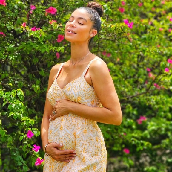 Yendi Phillipps holds her belly as she celebrates her latest pregnancy.