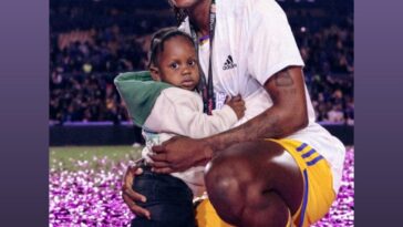 Konya Plummer celebrates the Liga MX Feminil title with Tigres alongside her son.