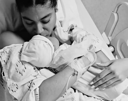 Yendi Phillipps holds her son, Isaiah, in the hospital after giving birth.
