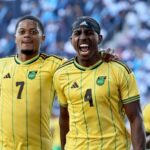 A'Mari Bell celebrates with his teammates after scoring for Jamaica in the 2023 Gold Cup against Guatemala.