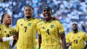 A'Mari Bell celebrates with his teammates after scoring for Jamaica in the 2023 Gold Cup against Guatemala.