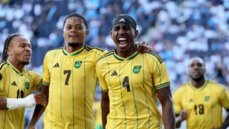 A'Mari Bell celebrates with his teammates after scoring for Jamaica in the 2023 Gold Cup against Guatemala.