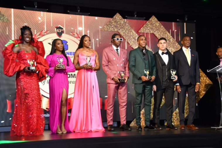 Shericka Jackson (far left) and Antonio Watson (middle) hold their respective RJR/Gleaner Sportswoman and Sportsman of the Year trophies.
