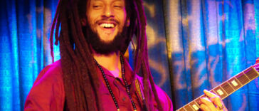 Julian Marley performs on his guitar during a show.