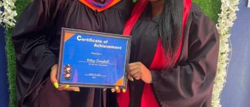 Shuga holds her graduation certificate on the set of her video for 'My Journey.'