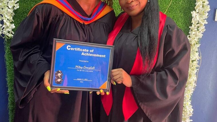 Shuga holds her graduation certificate on the set of her video for 'My Journey.'