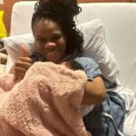 CVM morning host, Khadine "Miss Kitty" Hylton, holds her daughter after giving birth.
