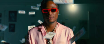 Masicka is surrounded by money in his new video for "Reverse Time."