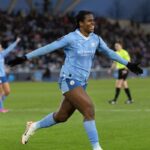 Khadija Shaw celebrates after scoring a goal.