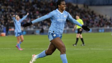 Khadija Shaw celebrates after scoring a goal.