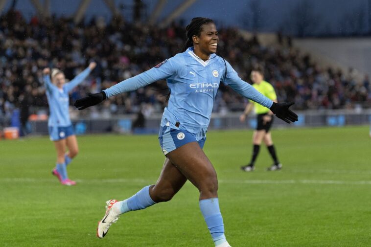 Khadija Shaw celebrates after scoring a goal.