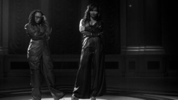 Lila Ike and H.E.R. pose during their music video for 'He Loves Us Both.'