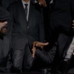 Damian Marley and Rygin King engage in conversation during the music video for 'Things Done Change.'