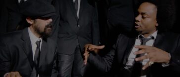 Damian Marley and Rygin King engage in conversation during the music video for 'Things Done Change.'