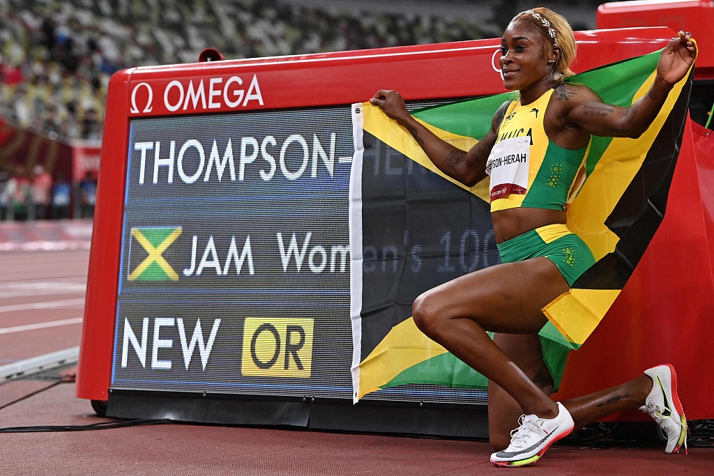 Elaine Thompson-Herah poses after breaking the Olympic women's 100m record at Tokyo 2020.