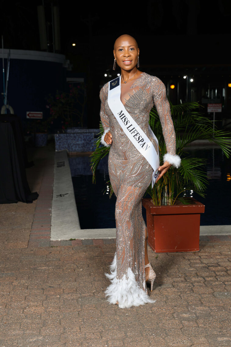 Dr. Sandra Swaby poses with her sash as she enters the Miss Universe Jamaica finals.