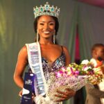 Tahje Bennett holds her award and flowers after being crowned the new Miss Jamaica World.