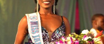 Tahje Bennett holds her award and flowers after being crowned the new Miss Jamaica World.