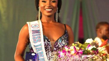 Tahje Bennett holds her award and flowers after being crowned the new Miss Jamaica World.